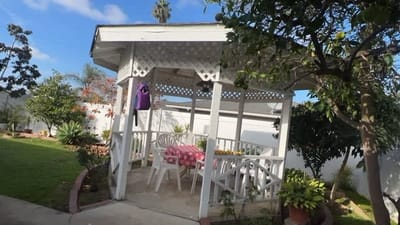 Outdoor gazebo with seating in a garden area