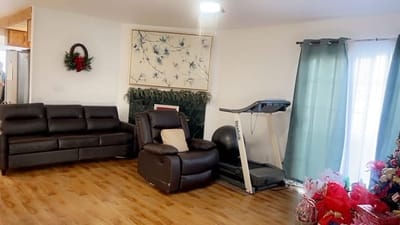 Comfortable interior lounge area with seating and treadmill