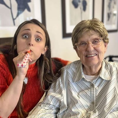 A resident and a staff member celebrating together