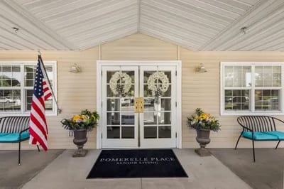 Entrance of Pomerelle Place Senior Living with decorative flowers