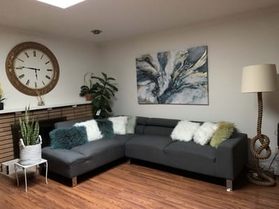 Cozy lounge area with a sectional sofa and art decor