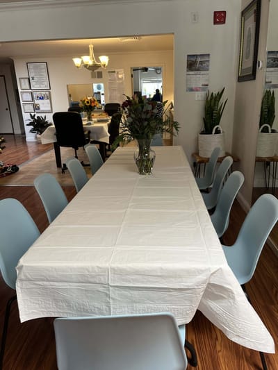 Interior view of a common area with a long table and chairs