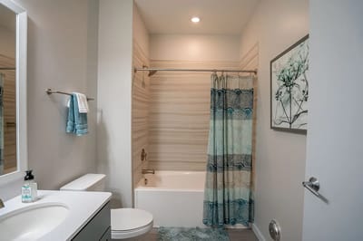 Clean and modern bathroom with decorative shower curtain