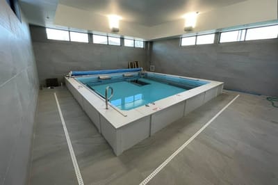 Indoor therapy pool area with windows