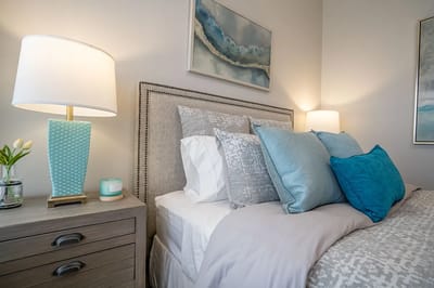 Cozy bedroom setup with decorative pillows and lamps