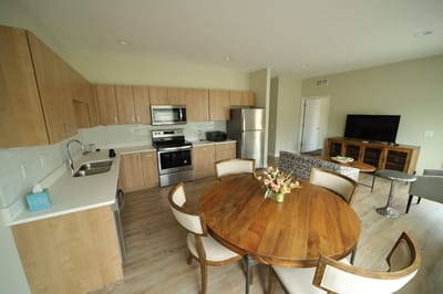 Bright kitchen area with a dining table and appliances