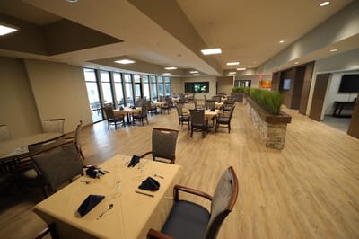 Bright dining room with tables set for meals