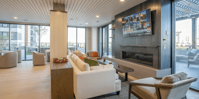 Bright common area with seating and a TV
