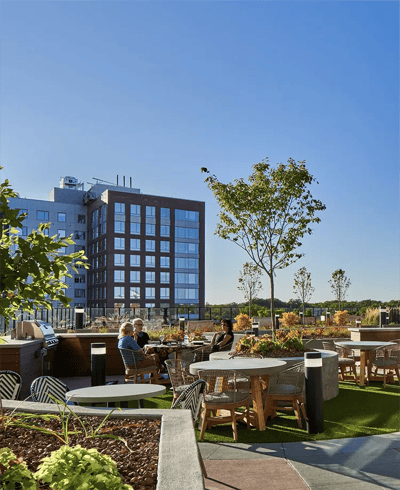 Residents enjoying the rooftop garden seating area