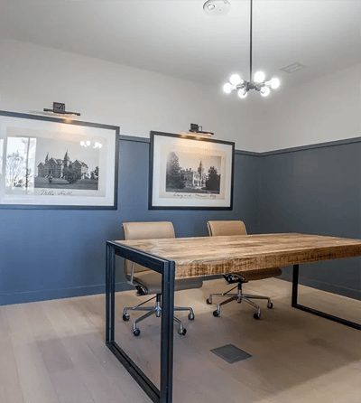 Modern meeting room with wooden table and artwork
