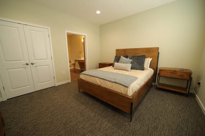 Cozy bedroom setup with wooden furniture and soft bedding