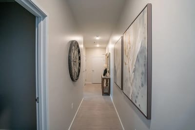 A hallway with decorative art and lighting