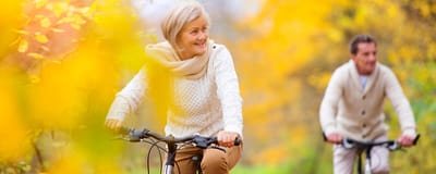 Residents biking outside in a colorful autumn setting