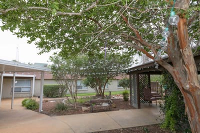 Outdoor patio area with seating and greenery