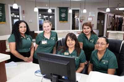 Staff members at the reception area with welcoming smiles