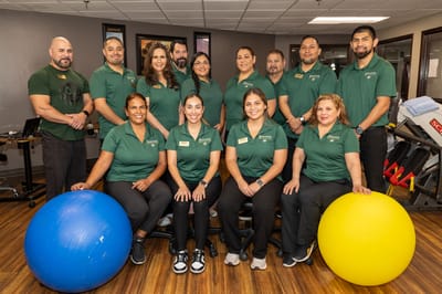 Staff members posing together in a rehabilitation facility