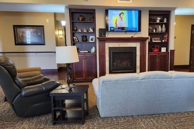 Interior view of a cozy common area with seating and fireplace