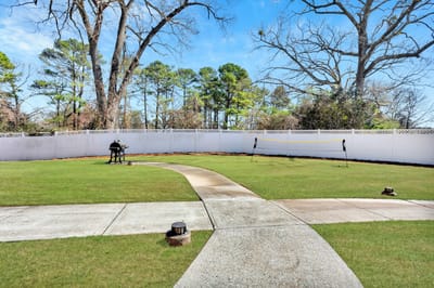 Well-maintained outdoor space with a paved walkway and trees