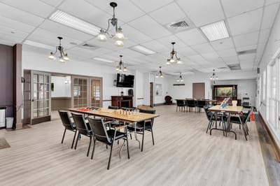 Bright activity room with tables and chairs for games