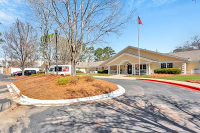 Exterior view of the facility with flag and landscaping