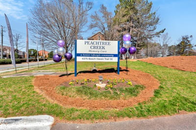 Sign for Peachtree Creek Memory Care with balloons