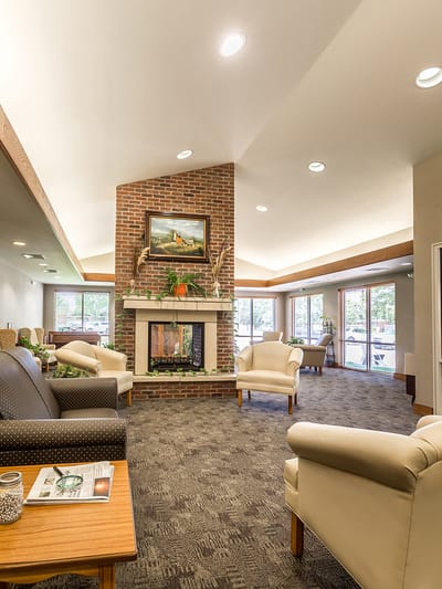Bright and inviting common area with seating and a fireplace