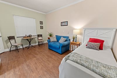 Cozy private resident room with a bed and seating area