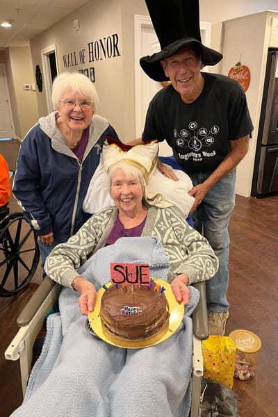 Residents celebrating a birthday with cake