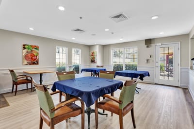 Dining area with tables and chairs in a bright room