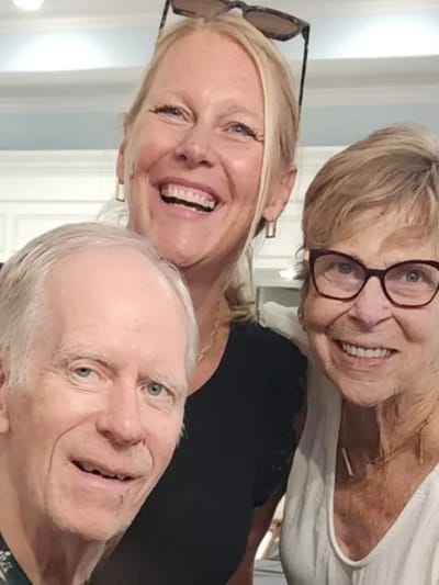 Residents and staff smiling together in a common area