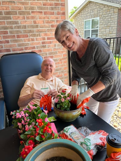 Residents and staff gardening together outdoors