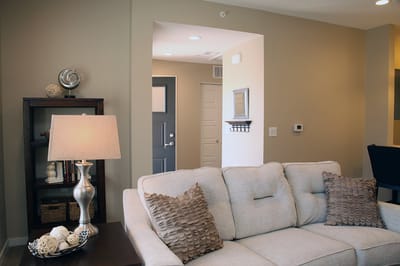 Cozy common area with a couch and lamp.