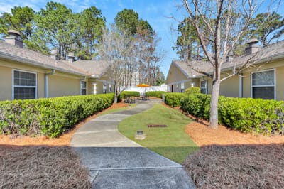 Pathway through landscaped outdoor space at the facility