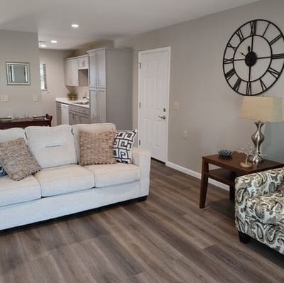 Well-decorated living room with sofa and clock