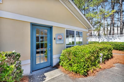 Exterior view of the facility entrance surrounded by greenery