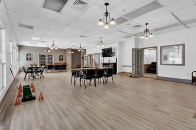 Bright activity room with tables and chairs