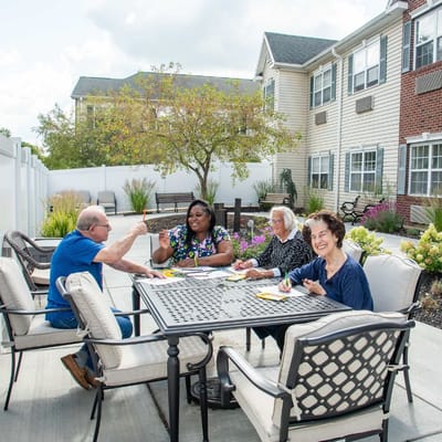 Residents enjoying an outdoor activity at a table
