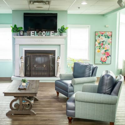 Cozy common area with a welcome fireplace and seating