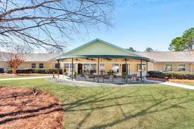 Exterior view of the assisted living facility with outdoor seating