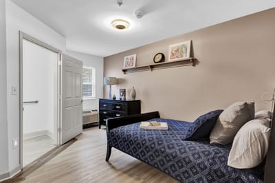Bright, cozy private resident room with bed and decor