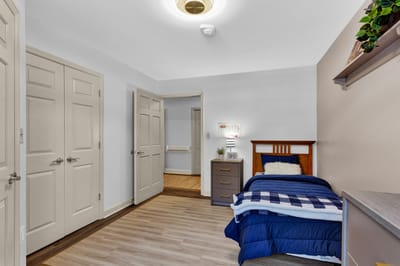 Cozy resident room with bed and dresser