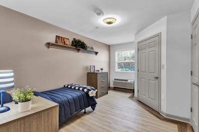 Private resident room with a bed and furniture