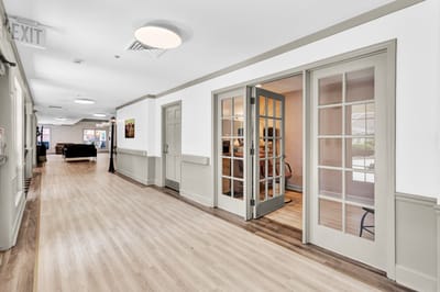 Bright interior hallway leading to a common area