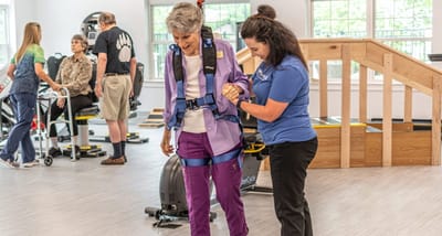 Therapist assisting a resident in an activity room