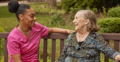 A caregiver and a resident enjoying time together outdoors