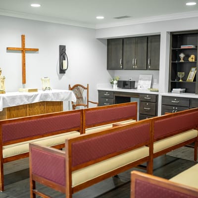 Interior view of a chapel with benches and altar