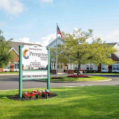 Exterior view of Peregrine Senior Living at Orchard Park with sign