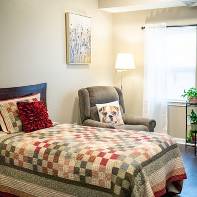 Cozy resident room with a bed and chair