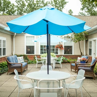 Outdoor seating area with blue umbrellas and plants