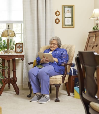 Resident reading in a cozy interior space